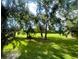 Large grassy backyard with mature trees providing shade at 50 Sheoah Blvd # 34, Winter Springs, FL 32708