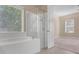 Bathroom with a shower, bathtub and bedroom access at 7997 Greengard St, Orlando, FL 32827