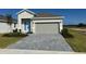 One-story house with light gray siding and a two-car garage at 3112 Windswept Way, Wildwood, FL 34785