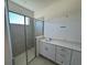 Spacious bathroom with double vanity and a walk-in shower at 3112 Windswept Way, Wildwood, FL 34785