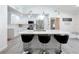 Modern kitchen with white cabinets, quartz countertops, and island seating at 2632 Muscatello St, Orlando, FL 32837