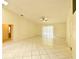 Spacious living room with tile floors and a ceiling fan at 8647 Otter Creek Ct, Orlando, FL 32829