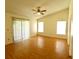 Bright bedroom with laminate wood floors and sliding glass doors at 8647 Otter Creek Ct, Orlando, FL 32829