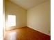 Simple bedroom with laminate wood floors and a large window at 8647 Otter Creek Ct, Orlando, FL 32829