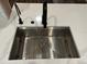 Modern stainless steel kitchen sink with a white quartz countertop at 6542 Merrick Landing Blvd, Windermere, FL 34786