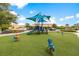 Community playground with play structures and shade sails at 4511 Monado Dr, Kissimmee, FL 34746