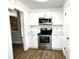 Modern kitchen with white shaker cabinets and stainless steel appliances at 666 Sausalito Blvd, Casselberry, FL 32707