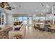 Open living room and kitchen with a stone fireplace and lake views at 6320 S Sylvan Lake Dr, Sanford, FL 32771
