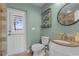 Bathroom features a pedestal sink, toilet and decorative wall art at 6320 S Sylvan Lake Dr, Sanford, FL 32771