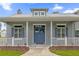 Gray house with blue double front doors and white porch railings at 6320 S Sylvan Lake Dr, Sanford, FL 32771