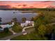 Waterfront property with large home and dock at sunset at 6320 S Sylvan Lake Dr, Sanford, FL 32771