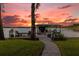 Stone walkway leading to a waterfront dock at sunset at 6320 S Sylvan Lake Dr, Sanford, FL 32771