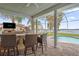 Outdoor kitchen with lake view and seating area at 6320 S Sylvan Lake Dr, Sanford, FL 32771