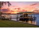 Covered boat dock on the lake at sunset at 6320 S Sylvan Lake Dr, Sanford, FL 32771