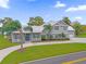 Two-story house with a metal roof and circular driveway near a lake at 6320 S Sylvan Lake Dr, Sanford, FL 32771