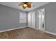 Bright bedroom with wood floors, double doors, and an ensuite bathroom at 6320 S Sylvan Lake Dr, Sanford, FL 32771