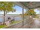 Relaxing screened porch overlooking a lake with a dock at 6320 S Sylvan Lake Dr, Sanford, FL 32771