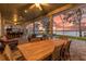 Relaxing covered patio with outdoor kitchen, dining area, and sunset view at 6320 S Sylvan Lake Dr, Sanford, FL 32771