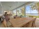 Lakefront patio with a large wooden dining table and comfortable wicker chairs at 6320 S Sylvan Lake Dr, Sanford, FL 32771