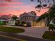 Two-story home with three-car garage at sunset at 6320 S Sylvan Lake Dr, Sanford, FL 32771