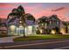 Two-story home with a three-car garage, and nicely landscaped lawn at 6320 S Sylvan Lake Dr, Sanford, FL 32771
