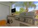 Stainless steel outdoor kitchen with grill and built-in entertainment at 6320 S Sylvan Lake Dr, Sanford, FL 32771