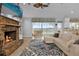 Spacious living room with a stone fireplace and lake views at 6320 S Sylvan Lake Dr, Sanford, FL 32771