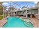 Large pool with a screened enclosure, a patio, and lake views at 6320 S Sylvan Lake Dr, Sanford, FL 32771