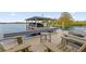 Relaxing lakefront dock with chairs and a small table at 6320 S Sylvan Lake Dr, Sanford, FL 32771