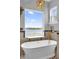 Relaxing bathroom with freestanding tub and water view at 6320 S Sylvan Lake Dr, Sanford, FL 32771