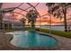 Relaxing screened pool overlooking the lake at sunset at 6320 S Sylvan Lake Dr, Sanford, FL 32771