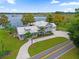 Lakefront home with a large yard and circular driveway at 6320 S Sylvan Lake Dr, Sanford, FL 32771