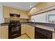 Galley kitchen with black appliances at 322 E Central Blvd # 1807, Orlando, FL 32801