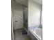 Elegant bathroom with a soaking tub and walk-in shower at 2521 Oneida Loop, Kissimmee, FL 34747