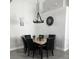 Elegant dining room with a marble table and six black chairs at 2521 Oneida Loop, Kissimmee, FL 34747