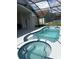 Inviting pool and spa with a screened enclosure at 2521 Oneida Loop, Kissimmee, FL 34747