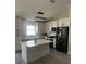 Modern kitchen featuring island, stainless steel appliances, and ample cabinetry at 2521 Oneida Loop, Kissimmee, FL 34747