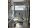 Clean bathroom with a walk-in shower and grey tile at 2521 Oneida Loop, Kissimmee, FL 34747