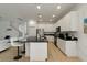 Modern kitchen with white cabinets, a large island with black countertop, and stainless steel appliances at 4511 Monado Dr, Kissimmee, FL 34746