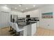 Modern kitchen with white cabinets, black countertops, and stainless steel appliances at 4511 Monado Dr, Kissimmee, FL 34746
