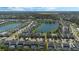 Aerial view of a lakefront community with numerous houses at 4511 Monado Dr, Kissimmee, FL 34746