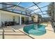 Inviting kidney-shaped pool with screened enclosure at 4511 Monado Dr, Kissimmee, FL 34746