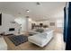 Open living space with white leather sectional and view into kitchen at 4511 Monado Dr, Kissimmee, FL 34746