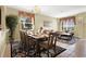 Spacious dining room with wooden table and seating for eight at 2615 Archfeld Blvd, Kissimmee, FL 34747