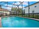 Inviting screened pool with a spa and decorative fencing at 2615 Archfeld Blvd, Kissimmee, FL 34747