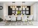 Elegant dining room with white chairs, gold accents, and modern light fixtures at 4537 Target Blvd, Kissimmee, FL 34746
