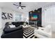 Living room with black leather sectional sofa, white accent chairs, and geometric rug at 4537 Target Blvd, Kissimmee, FL 34746
