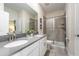 Main bathroom with double sinks, walk-in shower, and tile flooring at 4537 Target Blvd, Kissimmee, FL 34746
