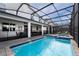 Enclosed pool and spa with patio and lounge chairs at 4537 Target Blvd, Kissimmee, FL 34746