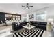 Open concept living area with black sectional sofa and dining area at 4537 Target Blvd, Kissimmee, FL 34746